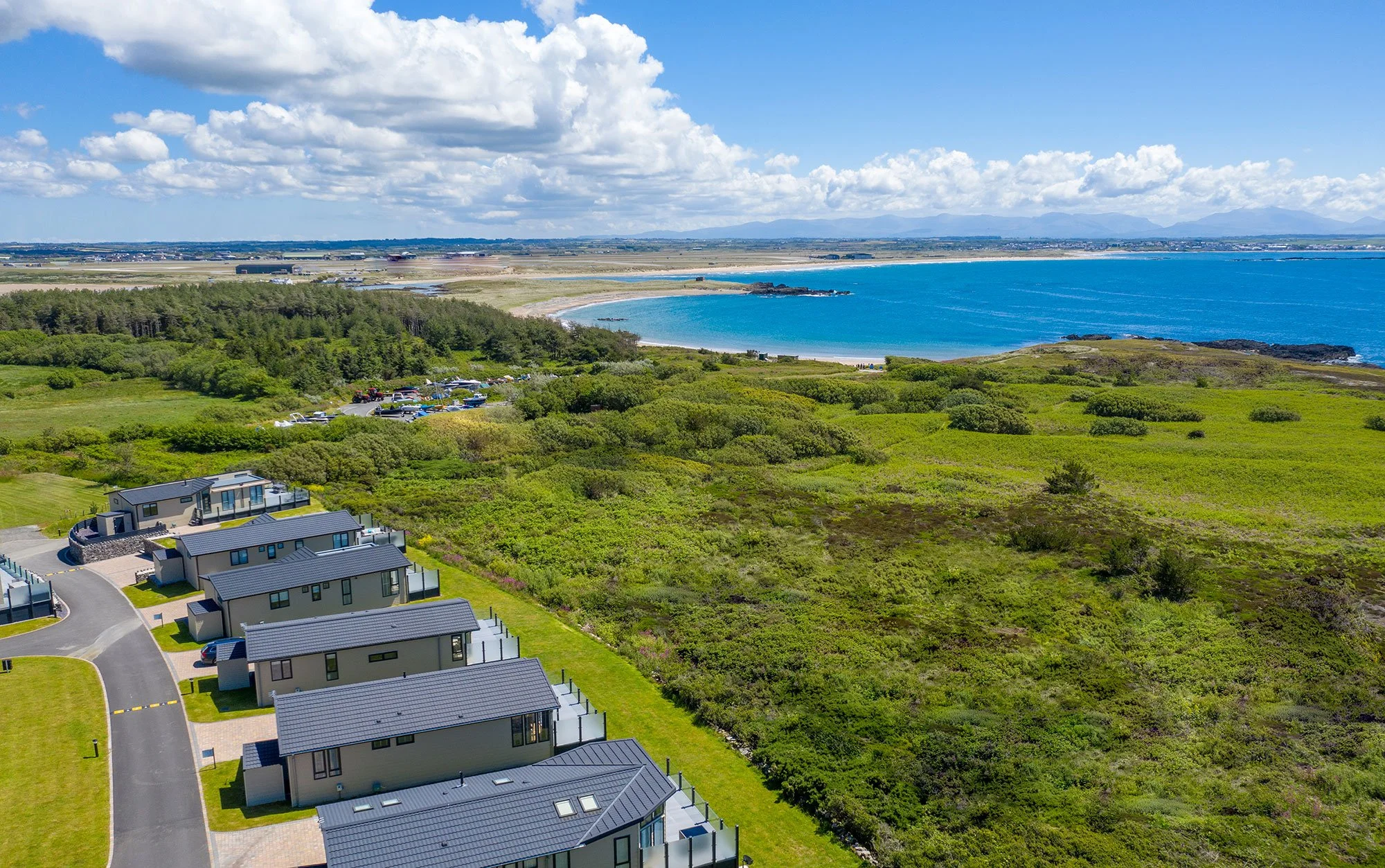 Aerial view of Silver Bay holiday-home park with the beach and bay beyond
