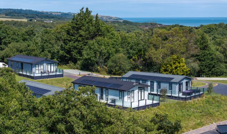 Lodges at Woodland Falls set in woodland above the sea