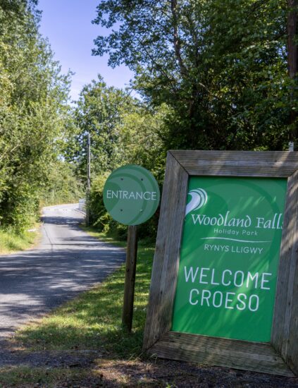 The Woodland Falls welcome sign at the park entrance